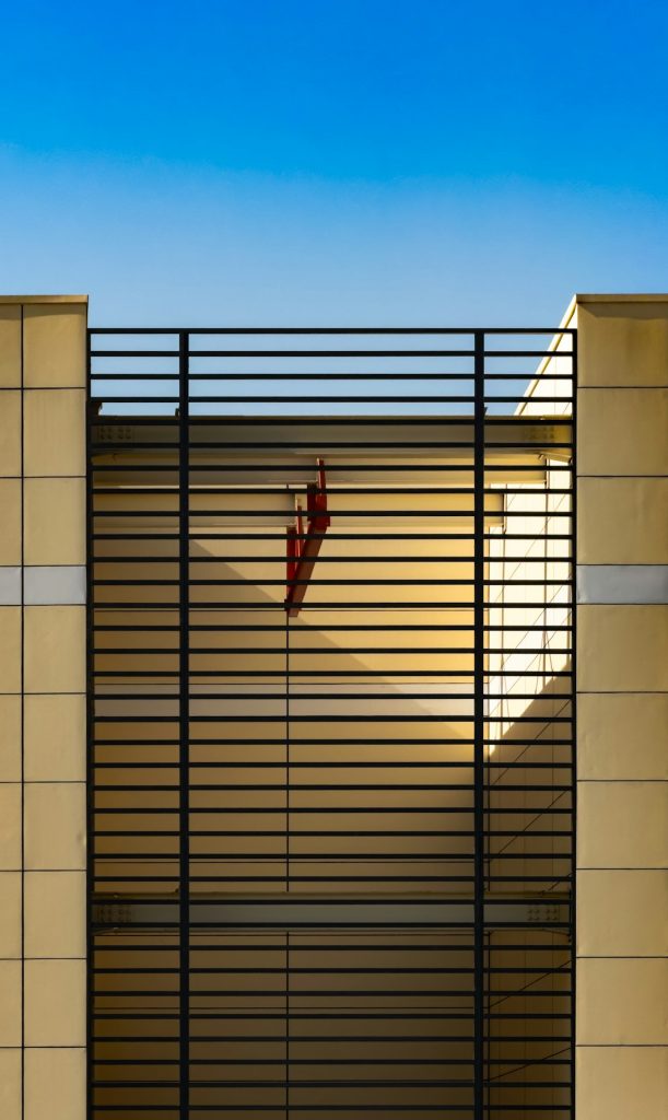 A tall building with a gate on the side of it