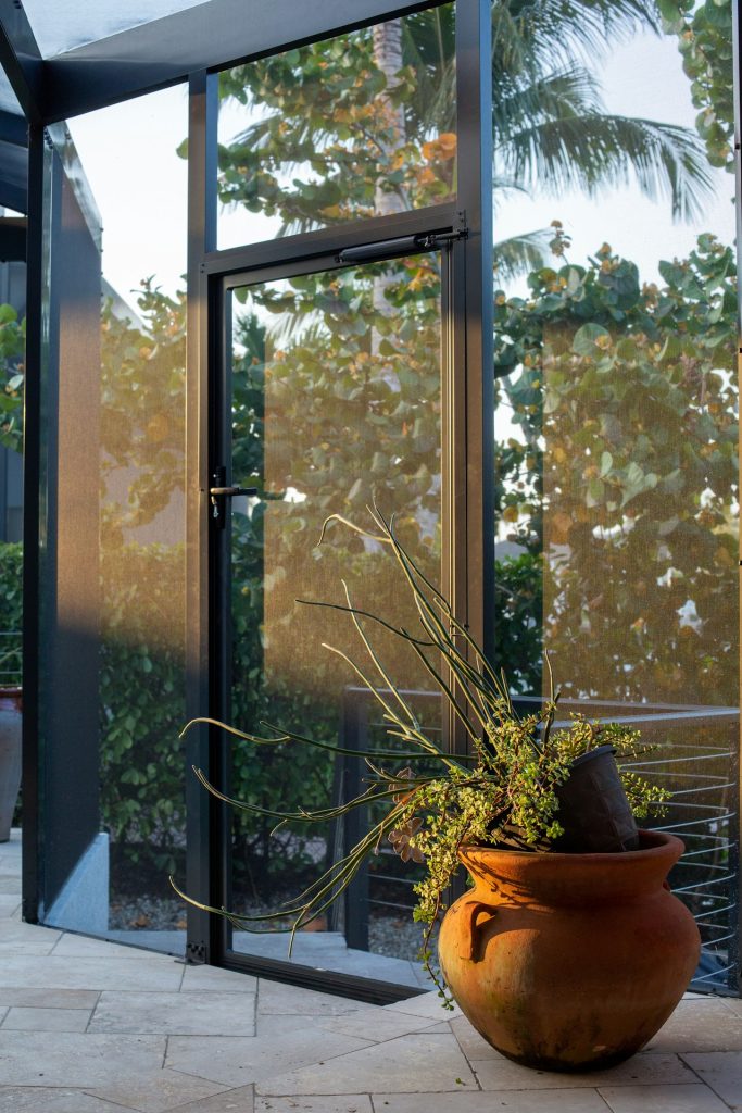 A large vase with a plant inside of it